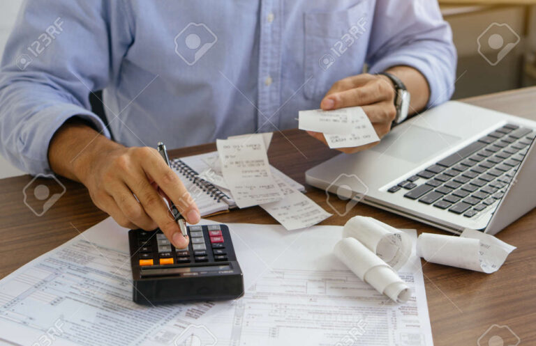 Impôt : Quels sont les avantages des frais réels par rapport à l'abattement 1 calculatrice et factures sur un bureau