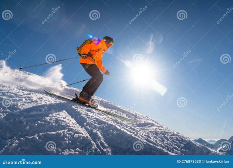 Comment trouver un emploi saisonnier en station de ski 35 skieur en action sur une montagne enneigee