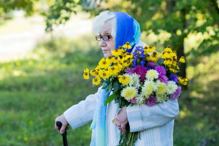 une main tenant une canne et des fleurs